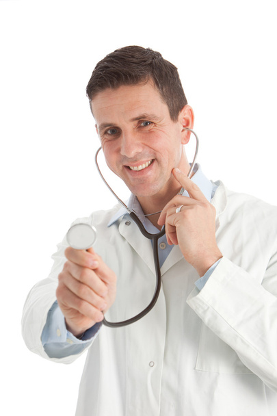 Friendly playful doctor holding out a stethoscope - Fotoğraf, Görsel