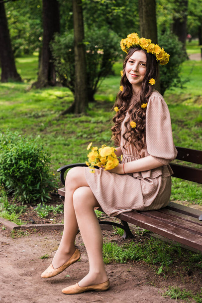 Fashion Summer Model Girl with Long Blowing Hair. Summer Beautiful Woman with Healthy and Beauty Brown Hair with Green Grass on Sunny Background - Φωτογραφία, εικόνα