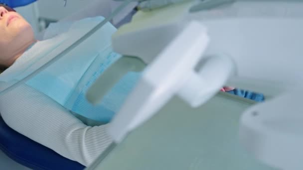 Dentist treating patient with special equipment  - Felvétel, videó