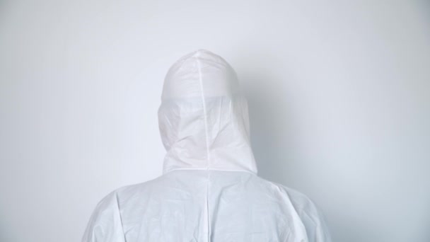 Portrait of a virologist in protective coverall and black mask - Séquence, vidéo
