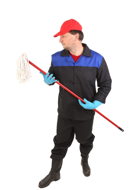 άνθρωπος με ρούχα εργασίας με σφουγγαρίστρα - Φωτογραφία, εικόνα