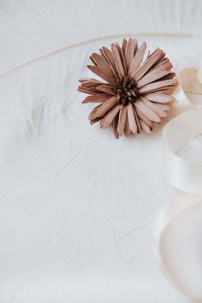 Dried flower and festive ribbon on white background. - Φωτογραφία, εικόνα
