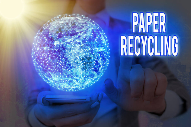 Handwriting text Paper Recycling. Concept meaning Using the waste papers in a new way by recycling them Elements of this image furnished by NASA. - Photo, Image