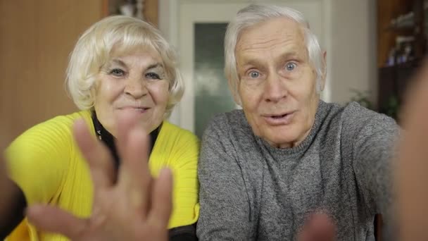 Pretty mature senior couple grandparents making video call message at home - Footage, Video