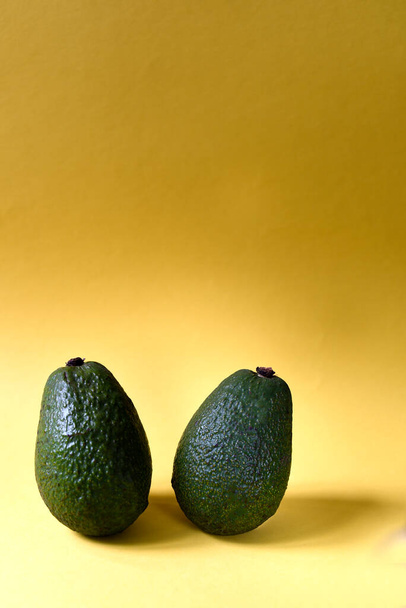 Fresh Avocado on a Yellow Background - Foto, Imagen