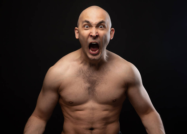 Photo of bald angry screaming man with bare shoulders - Foto, Bild