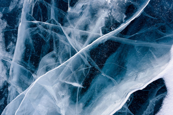 Prachtig blauw ijs van het Baikalmeer met abstracte scheuren - Foto, afbeelding