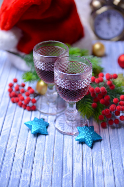 Wine glasses and Christmas decoration on bright background - Foto, Imagem