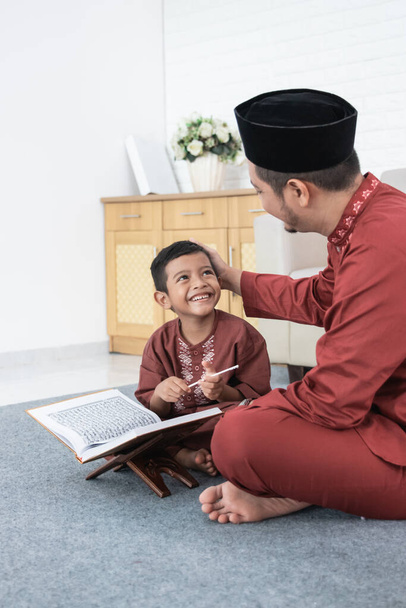 Son learns Quran with his father - Photo, image