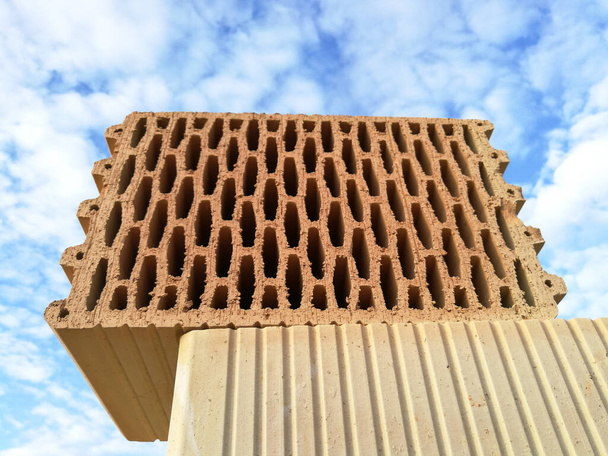 Ceramic building block for house building in the construction site close up in front of blue sky - Photo, Image
