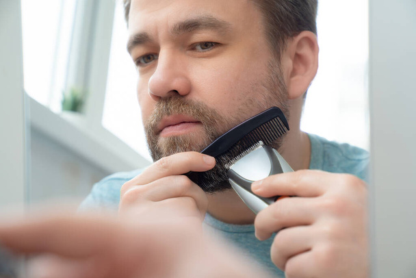 Man makes haircut of beard razor at home.  - Photo, Image