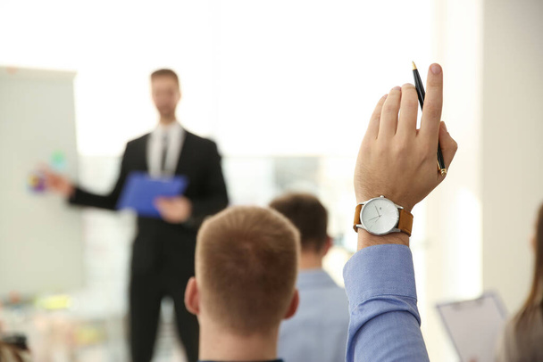 Man raising hand to ask question at business training indoors, closeup - Φωτογραφία, εικόνα