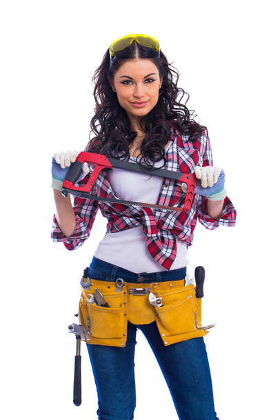 Project Satisfaction. Beautiful sexy housewife in goggles with a hacksaw in hand, isolated on white background - Foto, Bild