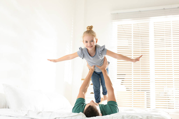 Dad and daughter having fun together at home. Happy Father's Day - Фото, зображення