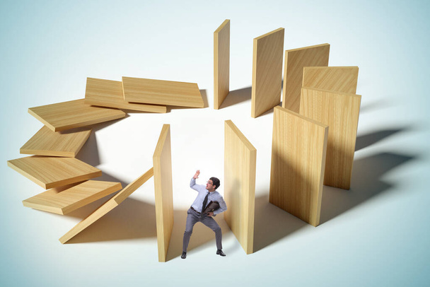 Businessman in domino effect concept - Photo, Image