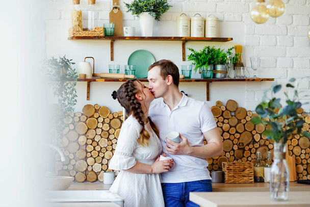A couple in love have a delicious Breakfast with coffee at home, copy space. Morning together. A pleasant time spent in the bright kitchen with your family. - Foto, Imagen
