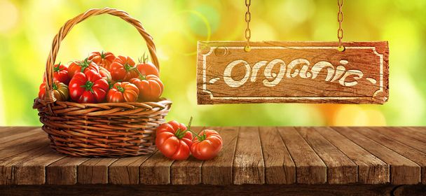 Freshly tomatoes in a basket on a wooden table - Foto, immagini