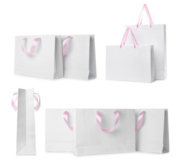 Set with paper shopping bags on white background - Foto, Bild