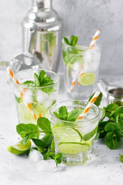 Refreshing summer alcoholic cocktail mojito with ice, fresh mint and lime - Fotó, kép