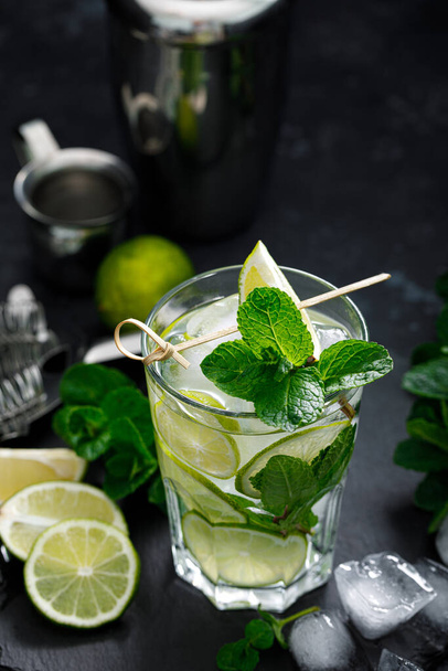 Refreshing summer alcoholic cocktail mojito with ice, fresh mint and lime - Photo, image