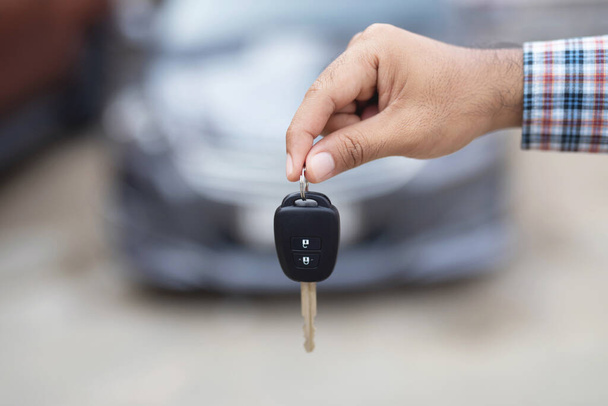 Satıcı, yeni araba anahtarlarını galerideki müşterilere teslim ediyor.. - Fotoğraf, Görsel