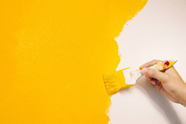 Механик рисует желтый на стене.
. - Фото, изображение