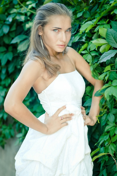Young woman in short white summer dress - Fotoğraf, Görsel