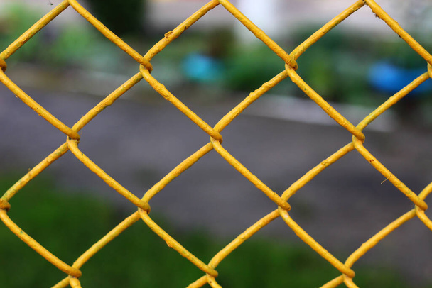 Colored chain link fence with blurry background - Photo, Image
