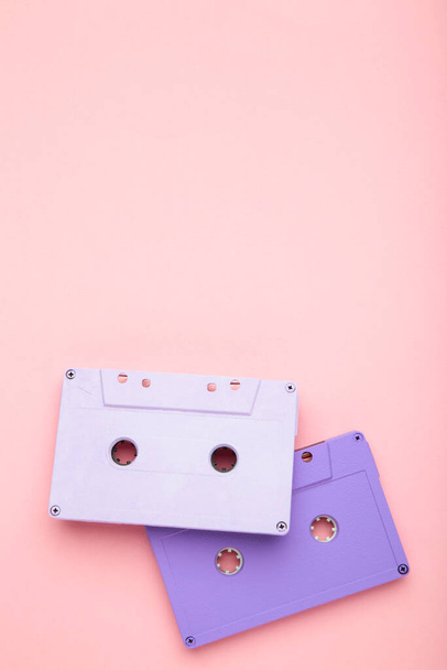 Two old colorful cassettes on a pink background. Music day, top view - Fotoğraf, Görsel
