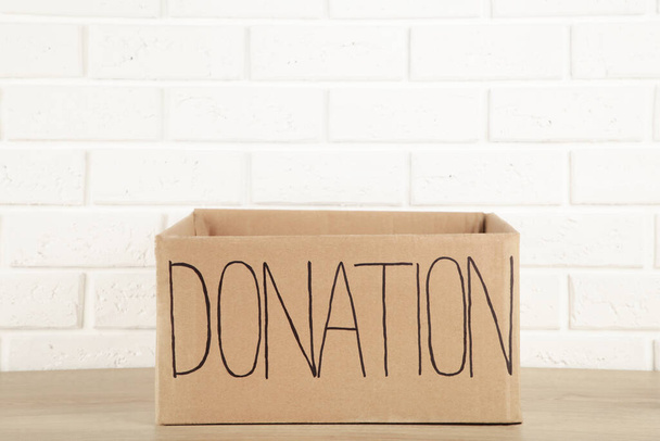 Empty cardboard donation box on white background. Top view - Foto, afbeelding