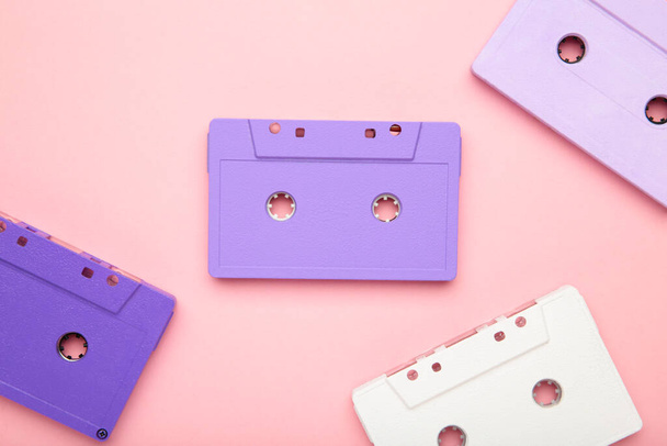 Old colorful cassettes on a pink background. Music day, top view - Φωτογραφία, εικόνα