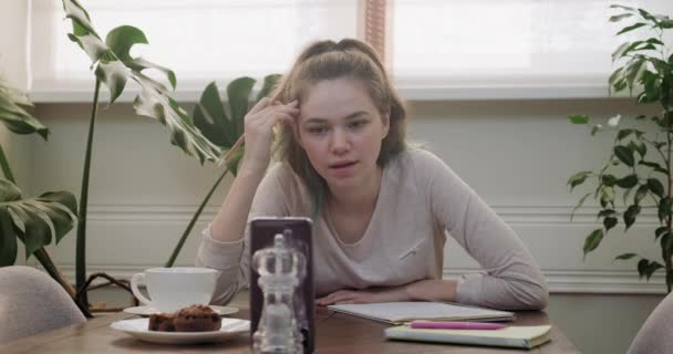 Girl teenager student talking on video communication using smartphone - Кадры, видео