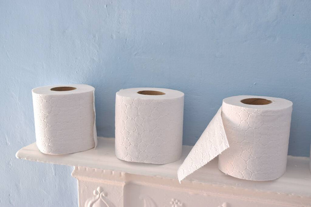 Toilet paper rolls on light blue background. - Foto, immagini