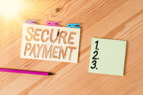 Conceptual hand writing showing Secure Payment. Business photo text Security of Payment refers to ensure of paid even in dispute Colored crumpled papers wooden floor background clothespin. - Photo, Image