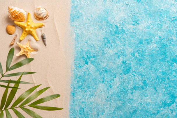 vacation and travel concept, Flat lay top view copy space, Minimal exotic concept. Creative layout of sand waves and sea, summer beach background with shell, sea star, and blurred Palm - Photo, image