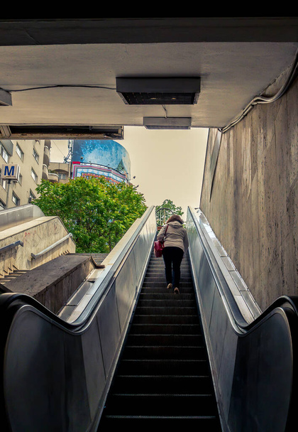 Woman on a escalator in a metro/subway station in Bucharest, Romania. - Photo, Image