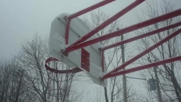 Basketball net covered with snow - Footage, Video