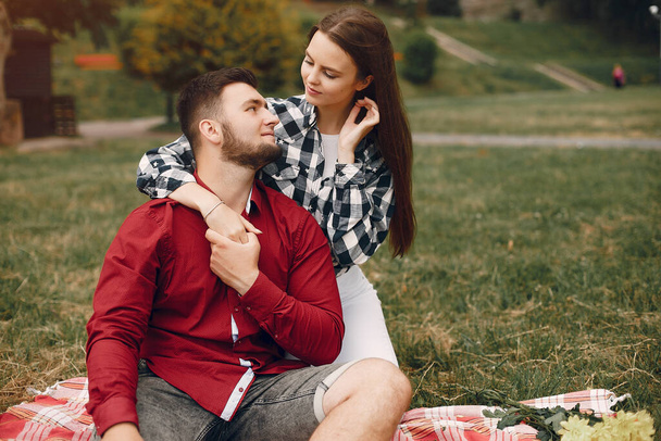 Beautiful couple spend time in a summer park - Fotó, kép