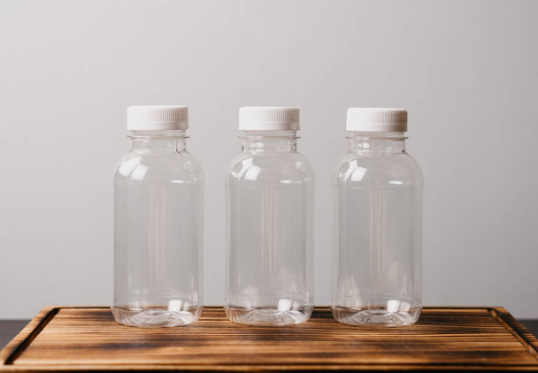Eco plastic bottles on colour background. - Фото, изображение