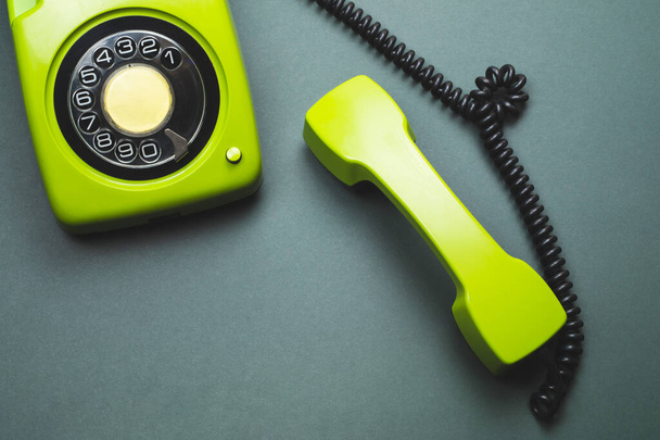 Classic phone with handset. vintage green telephone with phone receiver isolated on color background. old communication technology. copy space - Foto, imagen