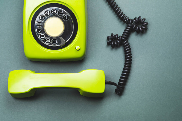 Classic phone with handset. vintage green telephone with phone receiver isolated on color background. old communication technology. copy space - Valokuva, kuva