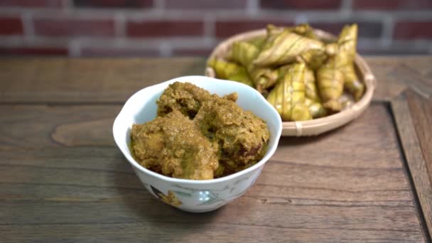 Cinematic shot of ketupat palas and chicken rendang, traditional malay cuisines typically served during eid - Footage, Video