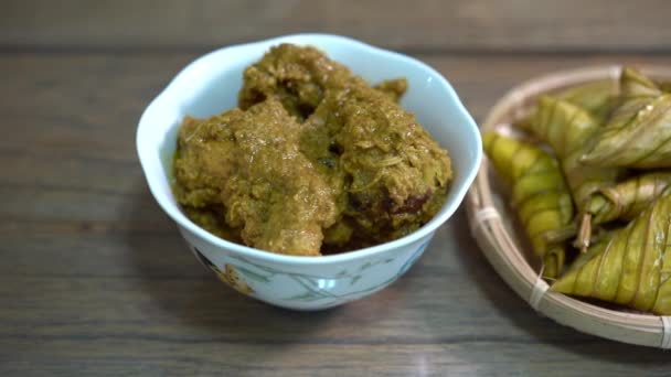Cinematic shot of ketupat palas and chicken rendang, traditional malay cuisines typically served during eid - Footage, Video