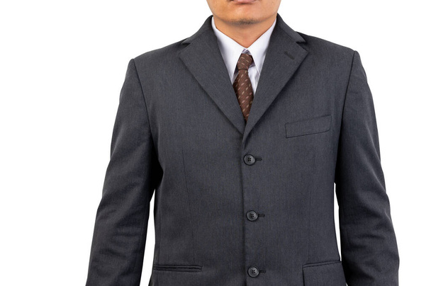 Бизнесмен в черном костюме, коричневом галстуке на изолированном фоне и с вырезанной дорожкой - Фото, изображение