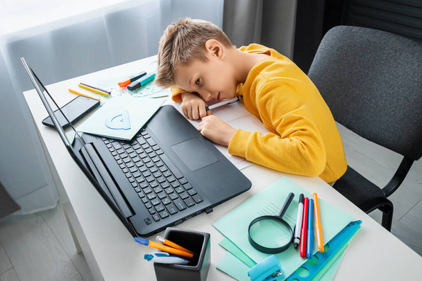 Distance learning, the boy fell asleep at the table doing homework. The concept of online education, home education, technology, school - Фото, зображення