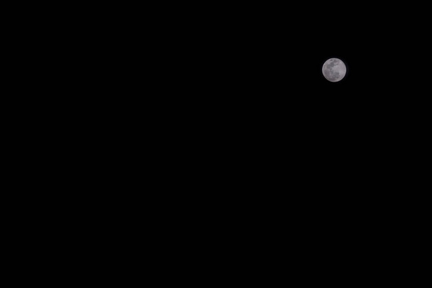 Full moon over the black sky at night. Nature background - Photo, Image