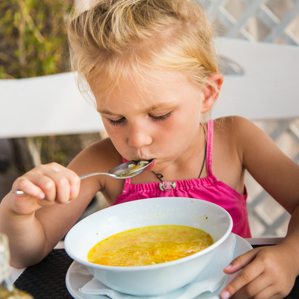 Cute child eating soup - Foto, immagini