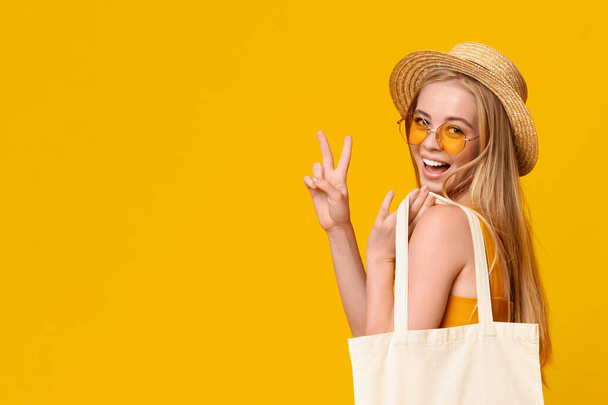 Stylish Girl In Straw Hat and Sunglasses Showing Peace Gesture
 - Фото, изображение