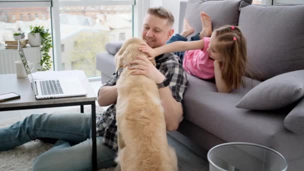 Smiling girl with father petting dog - Кадри, відео