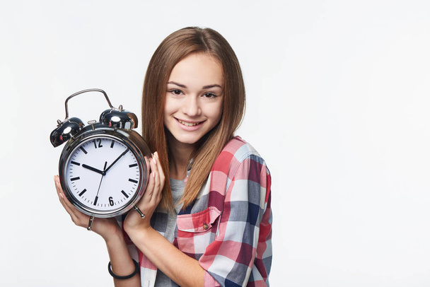 Portrait of smiling teen girl holding big clock - Foto, Imagen